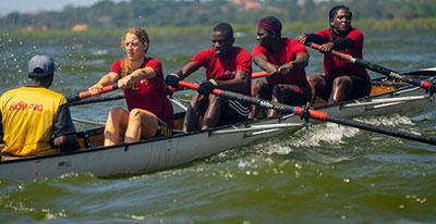 Kathleen Noble rowing with three others in a boat