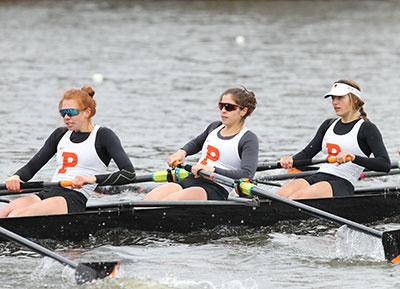 Kathleen Noble and two other women in Princeton uniforms rowing in a crew boat