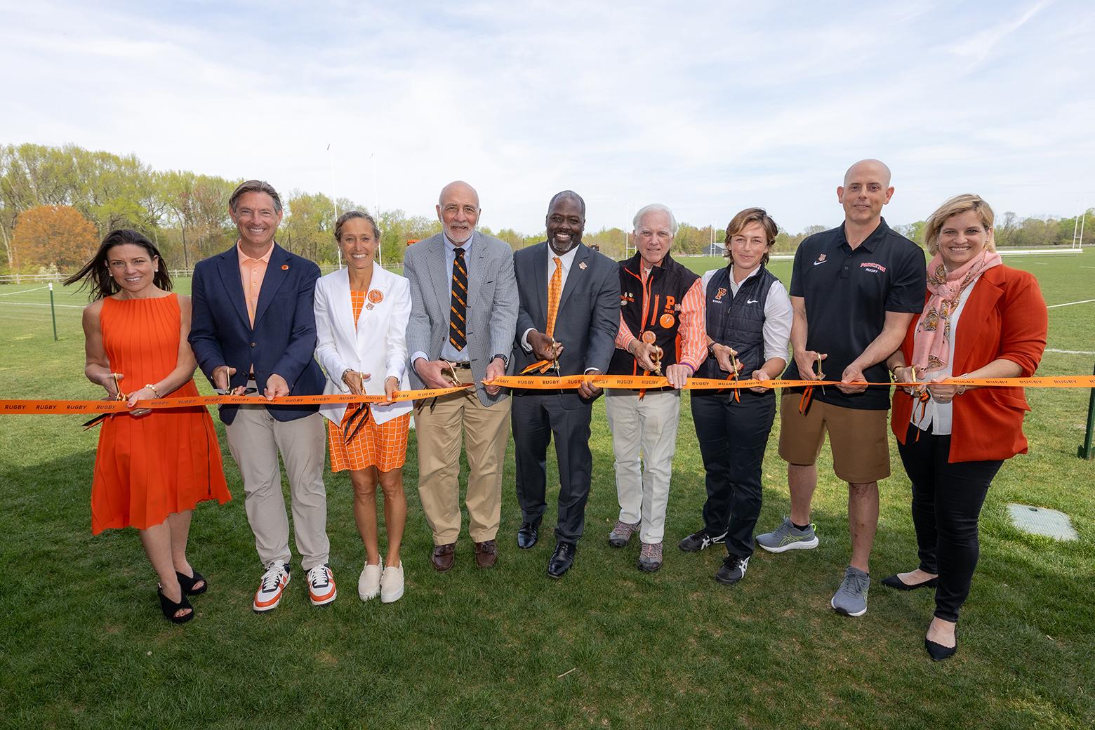 Rugby alumni and Princeton leadership cutting ribbon at dedication of Rugby facilities