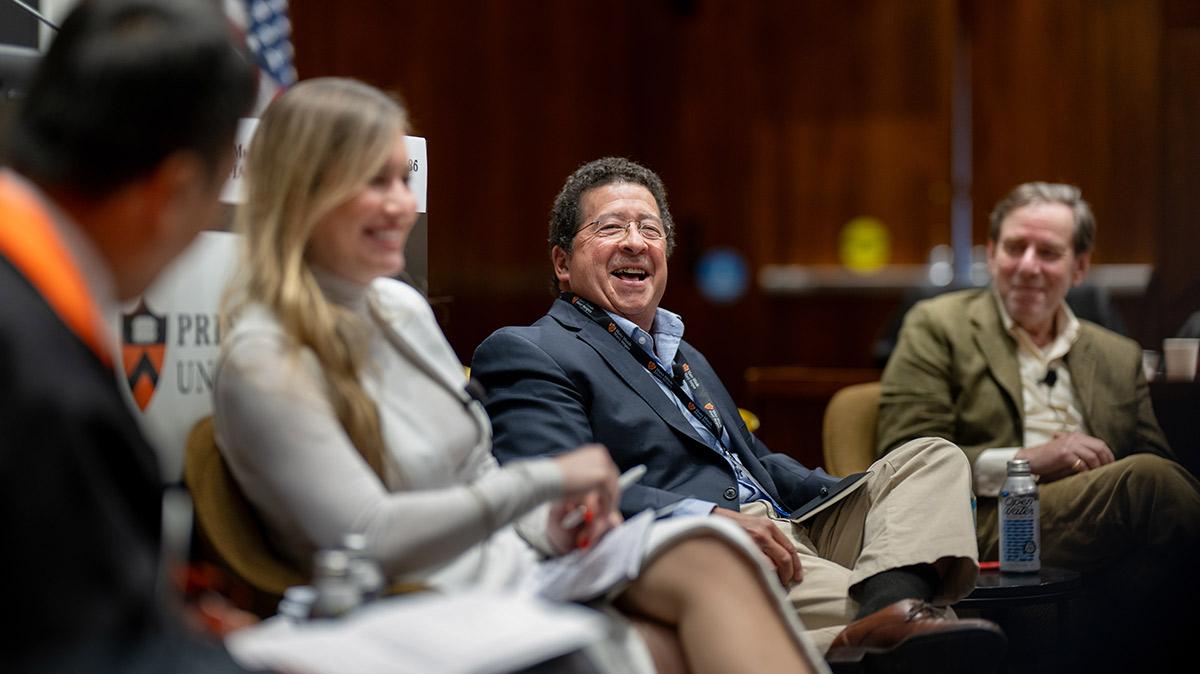David Goldwyn laughs alonside panelists in Robertson Hall during the Many Minds conference