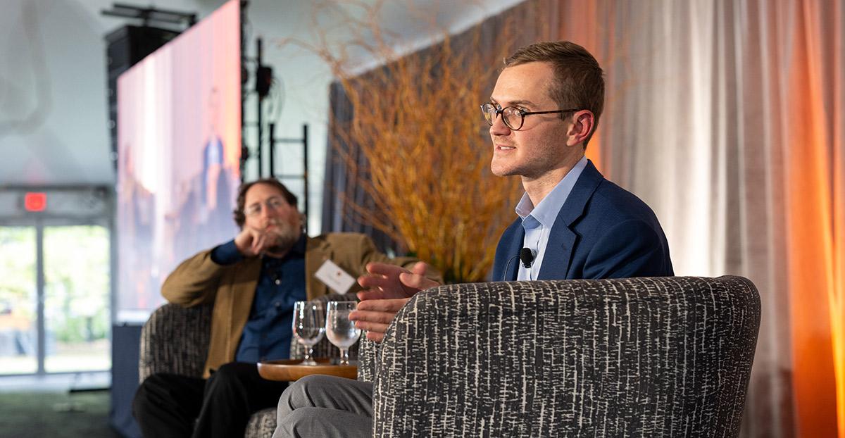 Judstin Silpe and Craig Arnold speak from the stage of Poe Tent during the Many Minds conference.