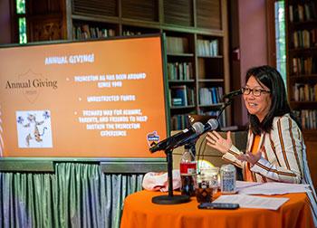 Deb Yu and a screen showing facts on Annual Giving