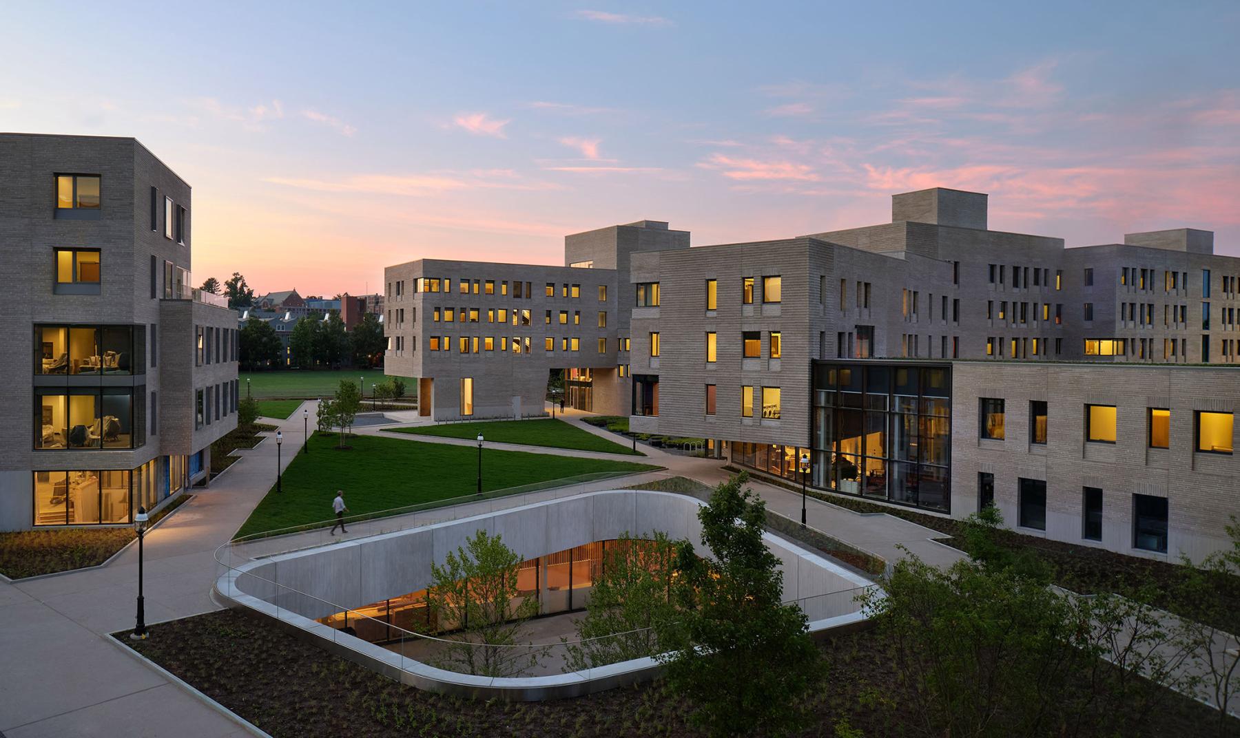 Yeh College and New College West at dusk, with green space and pathways connecting the two residential dorms.
