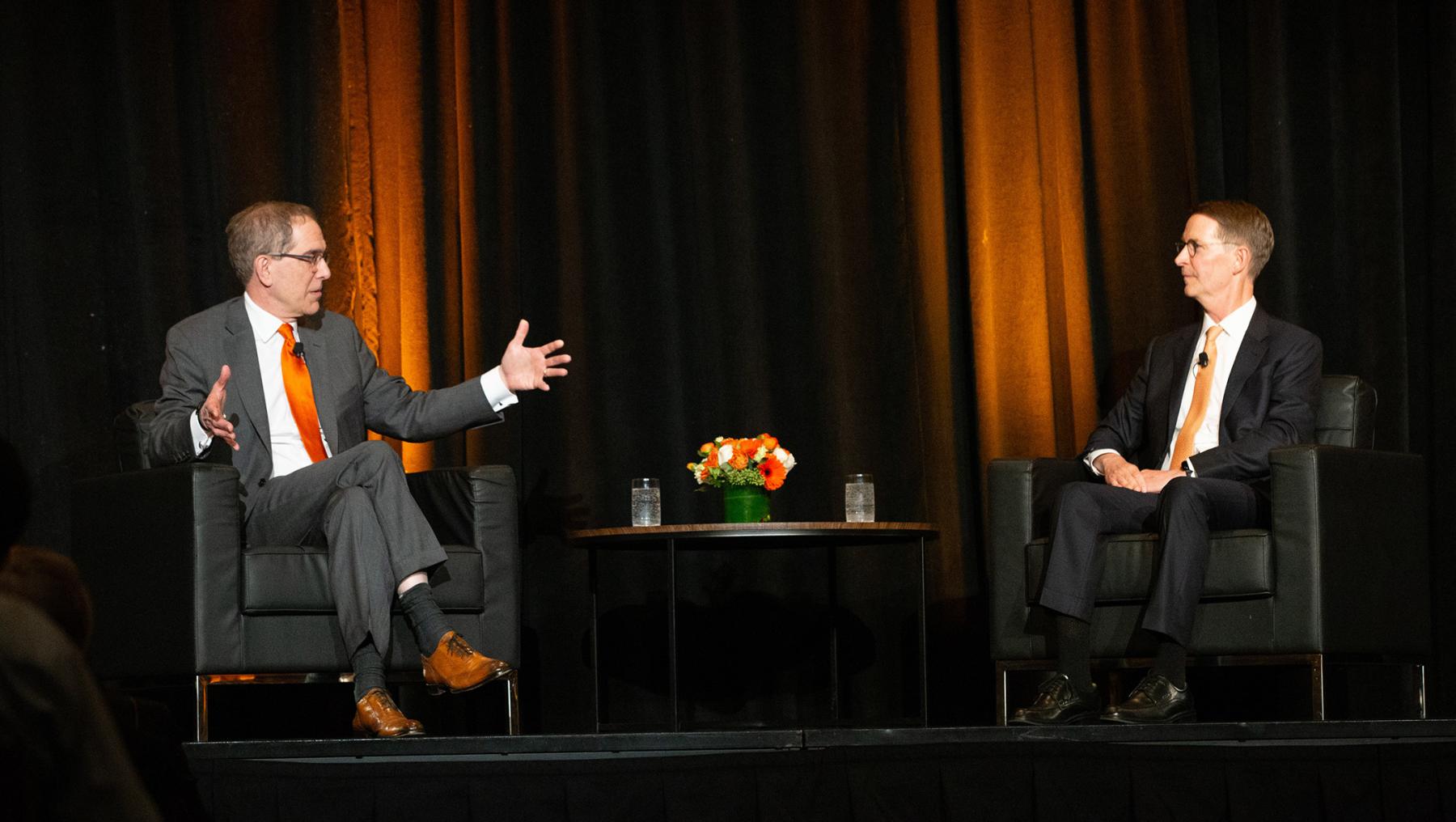 President Eisgruber on stage, seated opposite Bob Peck. 