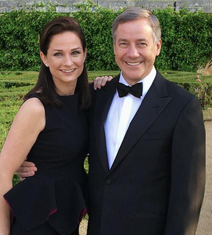 Heather and Andy Florance, shoulder to shoulder, wearing formal black evening wear. 