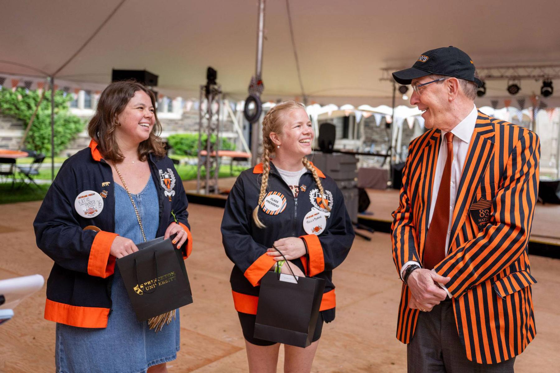 President Eisgruber talks with two alumni President Christopher L. Eisgruber (right) visits the 10th Reunion tent and talks with Class of 2016 members Katie Perez (left) and Kelly Byrne (center), the class president.