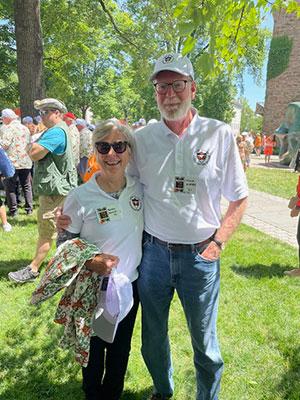 Bonnie Hewson and Chuck Marboe stand together outside on the grass